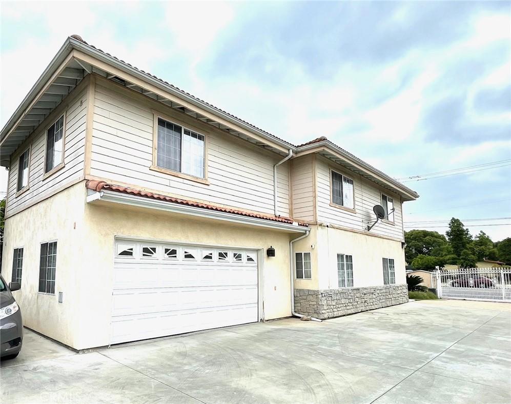 3717 Durfee Ave, El Monte, CA 91732 - view of front of house with driveway, stucco siding, a garage, and stone siding