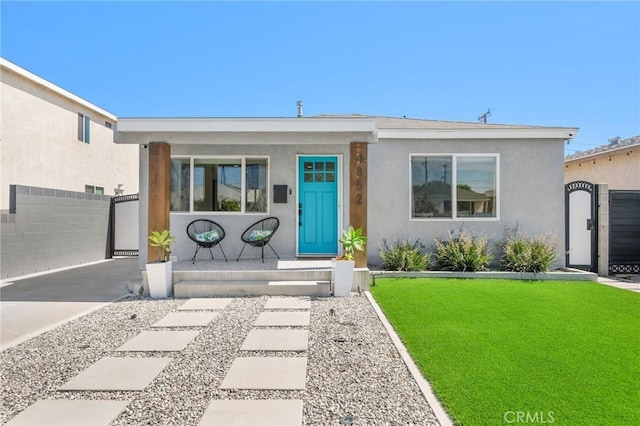 4852 W 129th St, Hawthorne, CA 90250 - view of front of property featuring a porch, stucco siding, and a gate