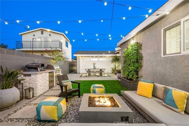 4852 W 129th St, Hawthorne, CA 90250 - fenced backyard featuring a patio area, exterior kitchen, and an outdoor living space with a fire pit