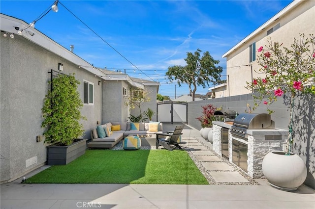 4852 W 129th St, Hawthorne, CA 90250 - view of yard with exterior kitchen, an outdoor hangout area, a gate, and a patio area