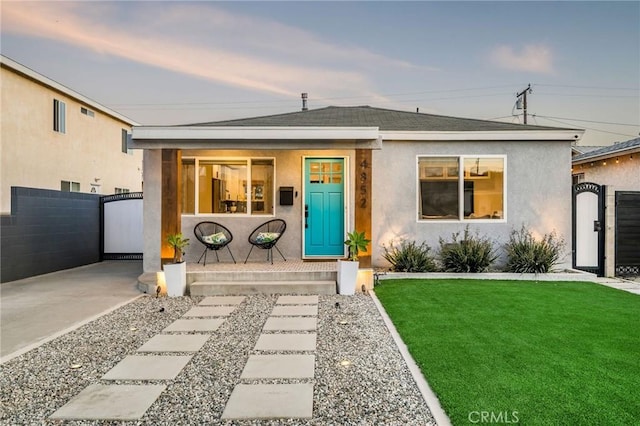 4852 W 129th St, Hawthorne, CA 90250 - bungalow-style home featuring a porch, stucco siding, roof with shingles, and a gate