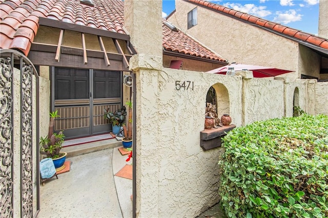 5471 E Centralia St Unit 24, Long Beach, CA 90808 - exterior view of a tiled roof, stucco siding, and a chimney