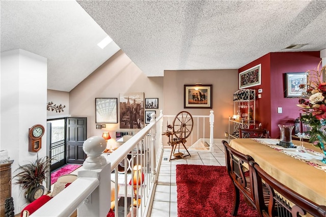 5471 E Centralia St Unit 24, Long Beach, CA 90808 - corridor with light tile patterned floors, a textured ceiling, and an upstairs landing