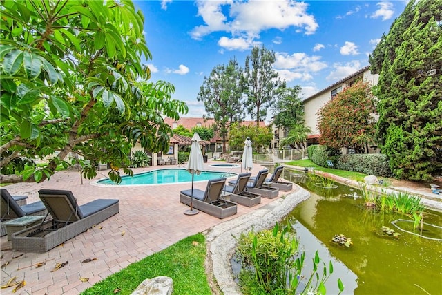 5471 E Centralia St Unit 24, Long Beach, CA 90808 - view of swimming pool featuring a patio
