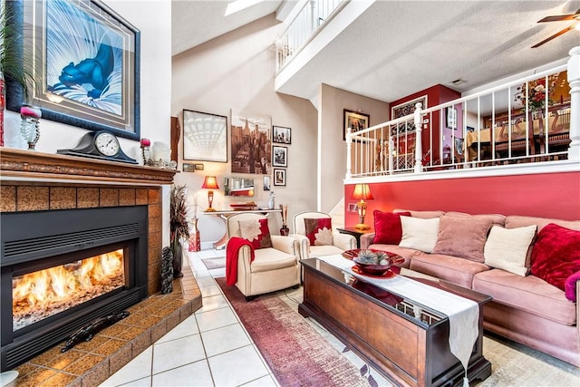 5471 E Centralia St Unit 24, Long Beach, CA 90808 - living area featuring a fireplace, tile patterned floors, stairway, a ceiling fan, and a textured ceiling