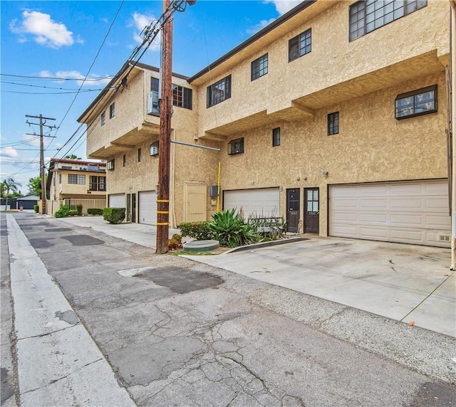 5471 E Centralia St Unit 24, Long Beach, CA 90808 - view of property with a garage and driveway