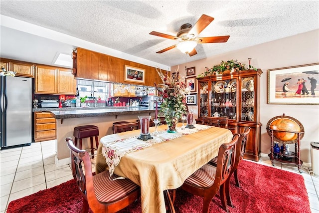 5471 E Centralia St Unit 24, Long Beach, CA 90808 - dining room featuring light tile patterned floors, a ceiling fan, and a textured ceiling
