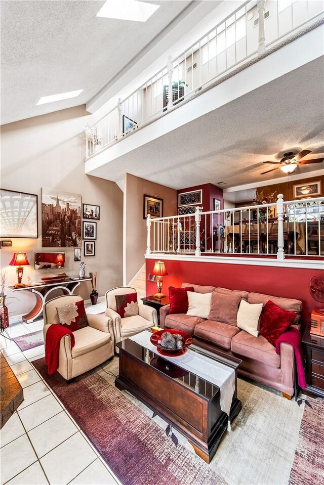 5471 E Centralia St Unit 24, Long Beach, CA 90808 - living room featuring a textured ceiling, stairway, tile patterned flooring, a high ceiling, and a ceiling fan