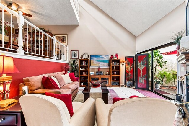 5471 E Centralia St Unit 24, Long Beach, CA 90808 - living area featuring stairs, a textured ceiling, ceiling fan, and vaulted ceiling