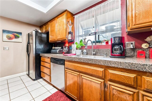 5471 E Centralia St Unit 24, Long Beach, CA 90808 - kitchen with stainless steel appliances, a sink, light tile patterned flooring, light countertops, and brown cabinets