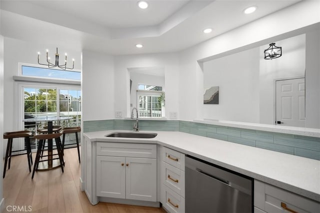 20092 Bayfront Ln Unit 206, Huntington Beach, CA 92646 - kitchen with stainless steel dishwasher, a sink, healthy amount of natural light, light countertops, and recessed lighting