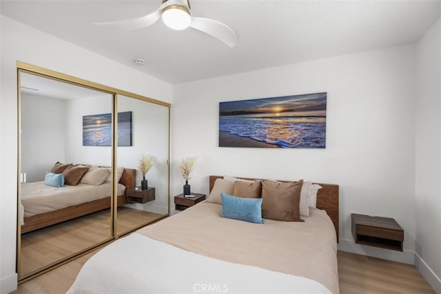 20092 Bayfront Ln Unit 206, Huntington Beach, CA 92646 - bedroom featuring light wood-style floors, a closet, ceiling fan, and baseboards