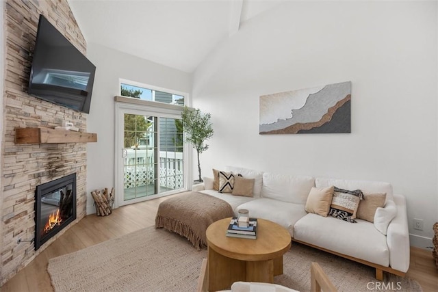 20092 Bayfront Ln Unit 206, Huntington Beach, CA 92646 - living area with wood finished floors, a fireplace, beamed ceiling, and high vaulted ceiling