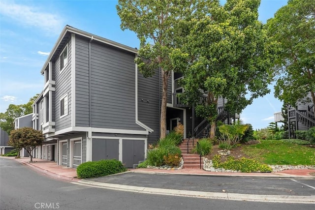 20092 Bayfront Ln Unit 206, Huntington Beach, CA 92646 - view of front of property with stairway and an attached garage