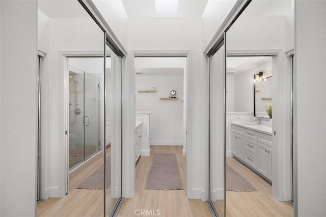 20092 Bayfront Ln Unit 206, Huntington Beach, CA 92646 - full bathroom featuring vanity, a stall shower, and wood finished floors