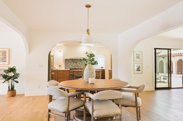 3728 Wawona Dr, San Diego, CA 92107 - dining room with arched walkways, light wood-style flooring, and baseboards