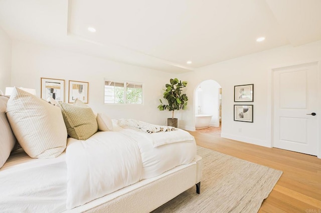 3728 Wawona Dr, San Diego, CA 92107 - bedroom featuring arched walkways, light wood-style floors, recessed lighting, baseboards, and ensuite bathroom