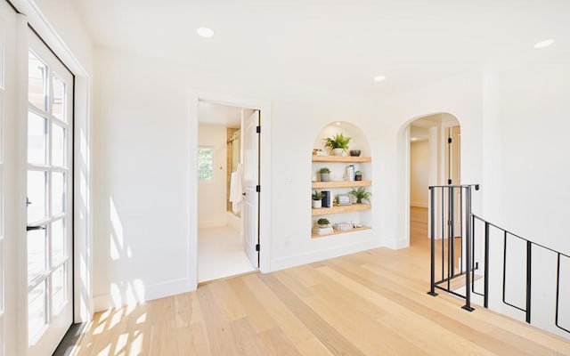 3728 Wawona Dr, San Diego, CA 92107 - hallway with built in shelves, light wood finished floors, arched walkways, baseboards, and recessed lighting