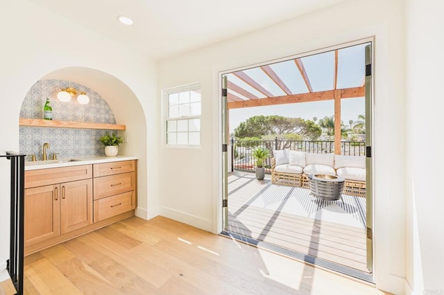 3728 Wawona Dr, San Diego, CA 92107 - doorway to outside featuring light wood-style floors, baseboards, bar with sink, and recessed lighting