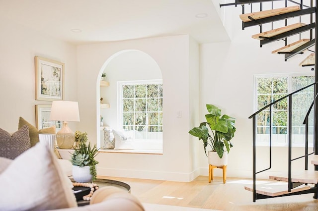3728 Wawona Dr, San Diego, CA 92107 - living area featuring wood finished floors, plenty of natural light, stairs, and arched walkways