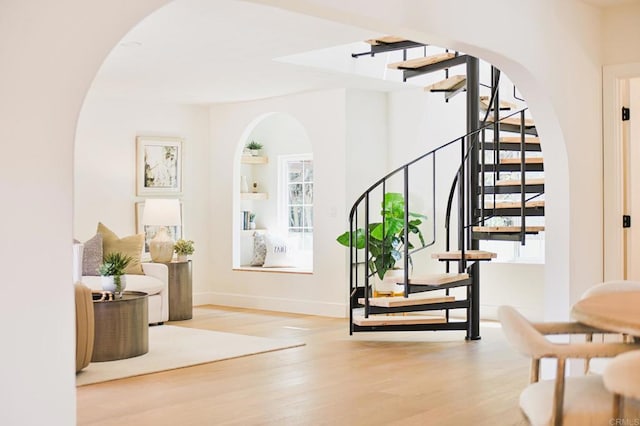 3728 Wawona Dr, San Diego, CA 92107 - staircase with healthy amount of natural light, arched walkways, wood finished floors, and baseboards
