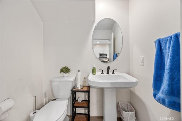 11437 Excelsior Dr Unit C, Norwalk, CA 90650 - half bath featuring toilet, baseboards, and wood finished floors