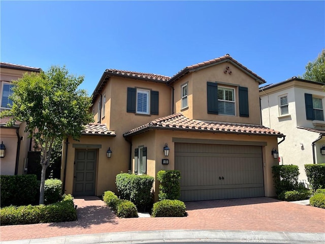123 Windham, Irvine, CA 92620 - mediterranean / spanish-style house with a tiled roof, an attached garage, stucco siding, and decorative driveway