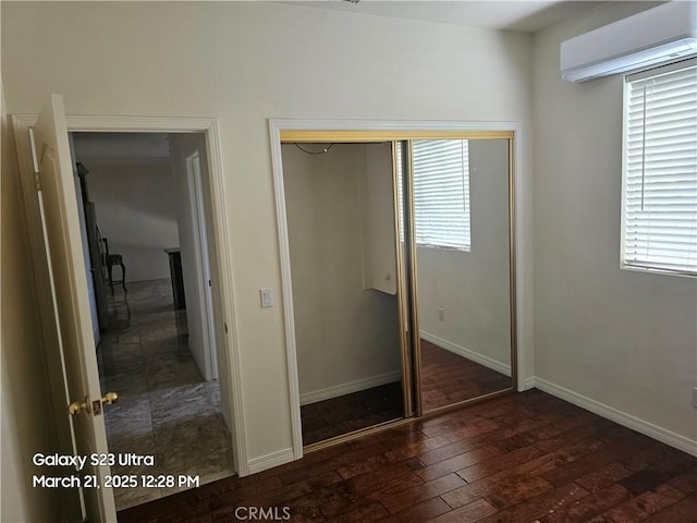 1849 10th Ave, Monrovia, CA 91016 - unfurnished bedroom with a wall unit AC, hardwood / wood-style floors, multiple windows, and a closet