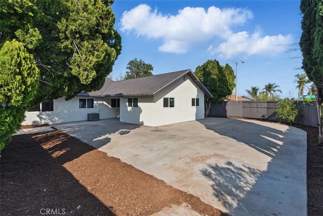 1551 Indian Trl, San Bernardino, CA 92407 - back of house with stucco siding, concrete driveway, a patio area, and a shingled roof
