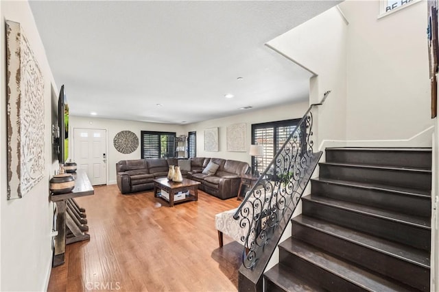 7925 Hemingway Ct, Fontana, CA 92336 - living area featuring stairway, plenty of natural light, wood finished floors, recessed lighting, and baseboards
