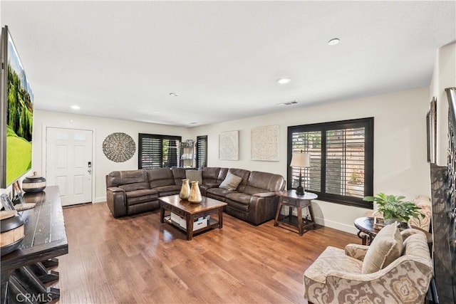 7925 Hemingway Ct, Fontana, CA 92336 - living area featuring light wood-type flooring, healthy amount of natural light, recessed lighting, and baseboards