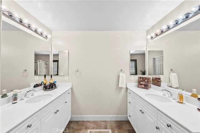 7925 Hemingway Ct, Fontana, CA 92336 - bathroom featuring two vanities, baseboards, and tile patterned floors