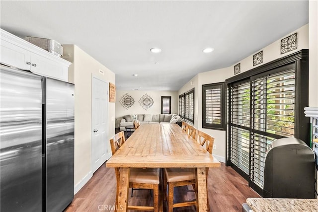 7925 Hemingway Ct, Fontana, CA 92336 - dining room with wood finished floors, baseboards, and recessed lighting