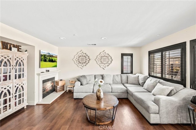 7925 Hemingway Ct, Fontana, CA 92336 - living room featuring a glass covered fireplace, dark wood-type flooring, recessed lighting, and baseboards