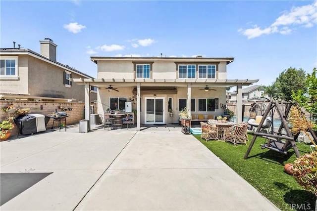 7925 Hemingway Ct, Fontana, CA 92336 - back of house with a ceiling fan, stucco siding, a fenced backyard, and an outdoor living space