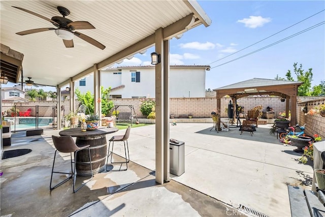 7925 Hemingway Ct, Fontana, CA 92336 - fenced backyard with a gazebo, ceiling fan, and a patio area