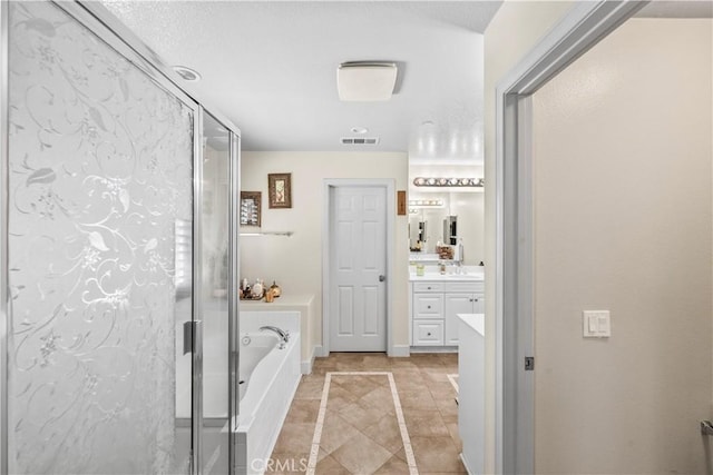 7925 Hemingway Ct, Fontana, CA 92336 - full bath with vanity, inlaid floor details, a bath, a shower stall, and tile patterned floors