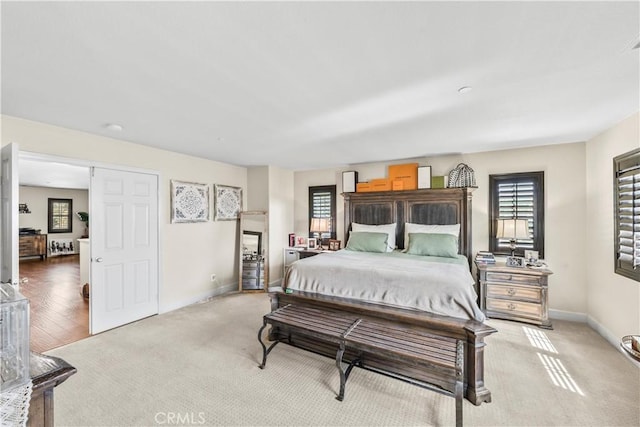 7925 Hemingway Ct, Fontana, CA 92336 - bedroom with multiple windows, baseboards, and light carpet