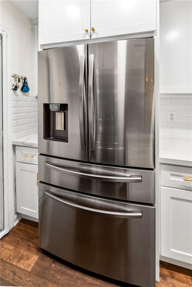 7890 E Spring St Unit 22F, Long Beach, CA 90815 - kitchen view of stainless steel refrigerator with ice dispenser, backsplash, white cabinets, and dark wood-type flooring