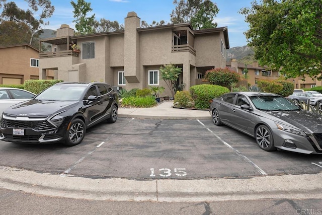 7398 Park View Ct Unit 135, Santee, CA 92071 - townhome / multi-family property with uncovered parking, stucco siding, and a chimney
