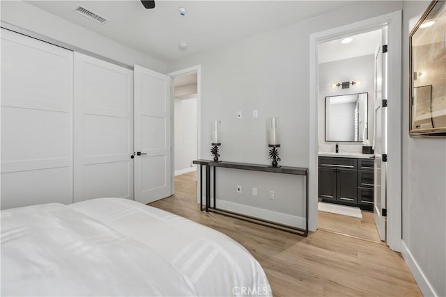 8126 Santaluz Village N, San Diego, CA 92127 - bedroom with light wood-style floors, connected bathroom, and baseboards