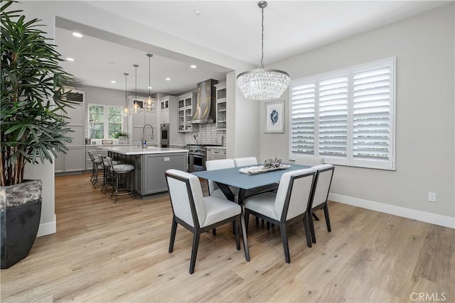 8126 Santaluz Village N, San Diego, CA 92127 - dining room featuring a chandelier, light wood-type flooring, recessed lighting, and baseboards