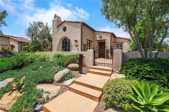 8126 Santaluz Village N, San Diego, CA 92127 - mediterranean / spanish-style house with stucco siding, a chimney, a gate, a fenced front yard, and a tiled roof