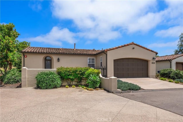 8126 Santaluz Village N, San Diego, CA 92127 - mediterranean / spanish house with a tile roof, stucco siding, an attached garage, and driveway