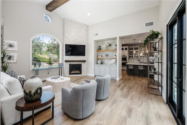 8126 Santaluz Village N, San Diego, CA 92127 - living room featuring high vaulted ceiling, light wood-style flooring, beam ceiling, a fireplace, and recessed lighting