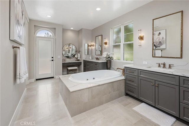 8126 Santaluz Village N, San Diego, CA 92127 - bathroom featuring plenty of natural light, a tub with jets, two vanities, tile patterned flooring, and recessed lighting