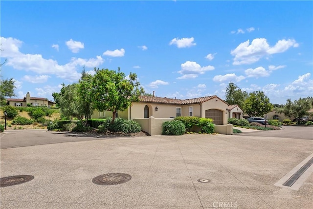8126 Santaluz Village N, San Diego, CA 92127 - mediterranean / spanish house with an attached garage, stucco siding, a tile roof, and driveway