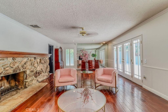 1169 Lyndhurst Dr, Riverside, CA 92507 - living area featuring hardwood / wood-style flooring, crown molding, a textured ceiling, wainscoting, and french doors