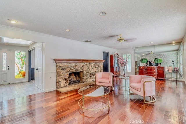 1169 Lyndhurst Dr, Riverside, CA 92507 - living area featuring wood finished floors, a textured ceiling, a fireplace, and a ceiling fan