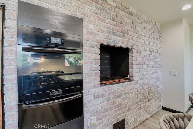 1169 Lyndhurst Dr, Riverside, CA 92507 - kitchen featuring a warming drawer, wood finished floors, baseboards, and stainless steel double oven